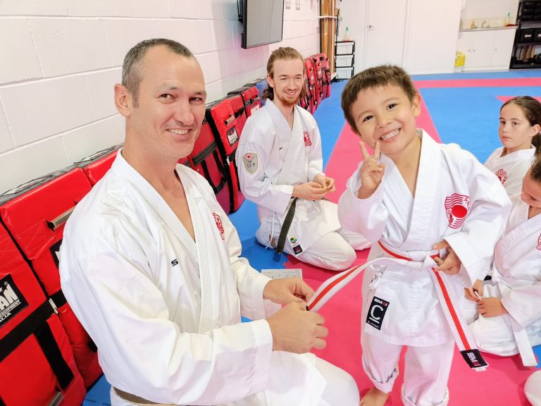 Little Champions celebrating an achievement with their instructor