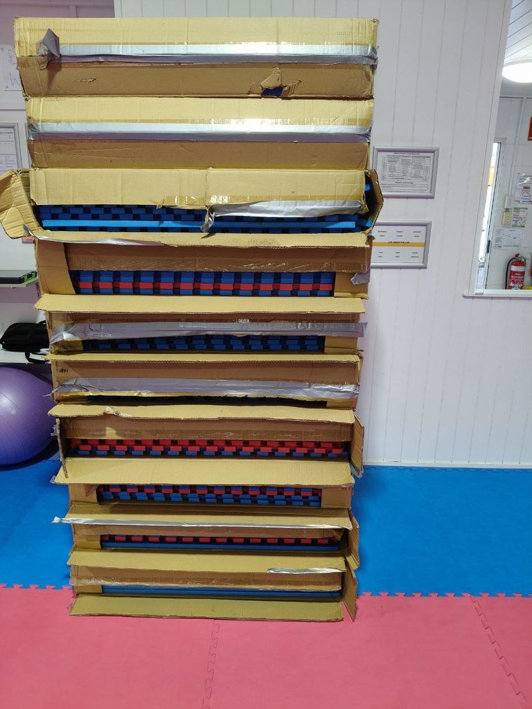 The old dojo mats, stacked and for sale