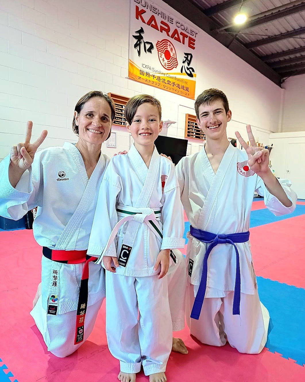 Sensei Sandra with a young student and a teenage student