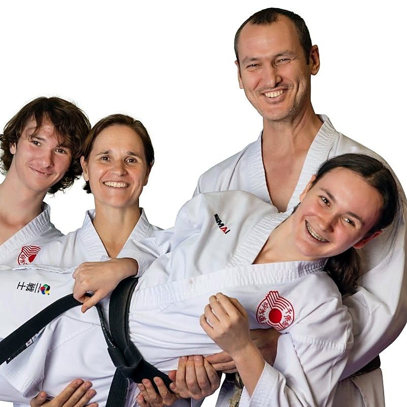 Sandra and Martin with their family, all in karate uniforms