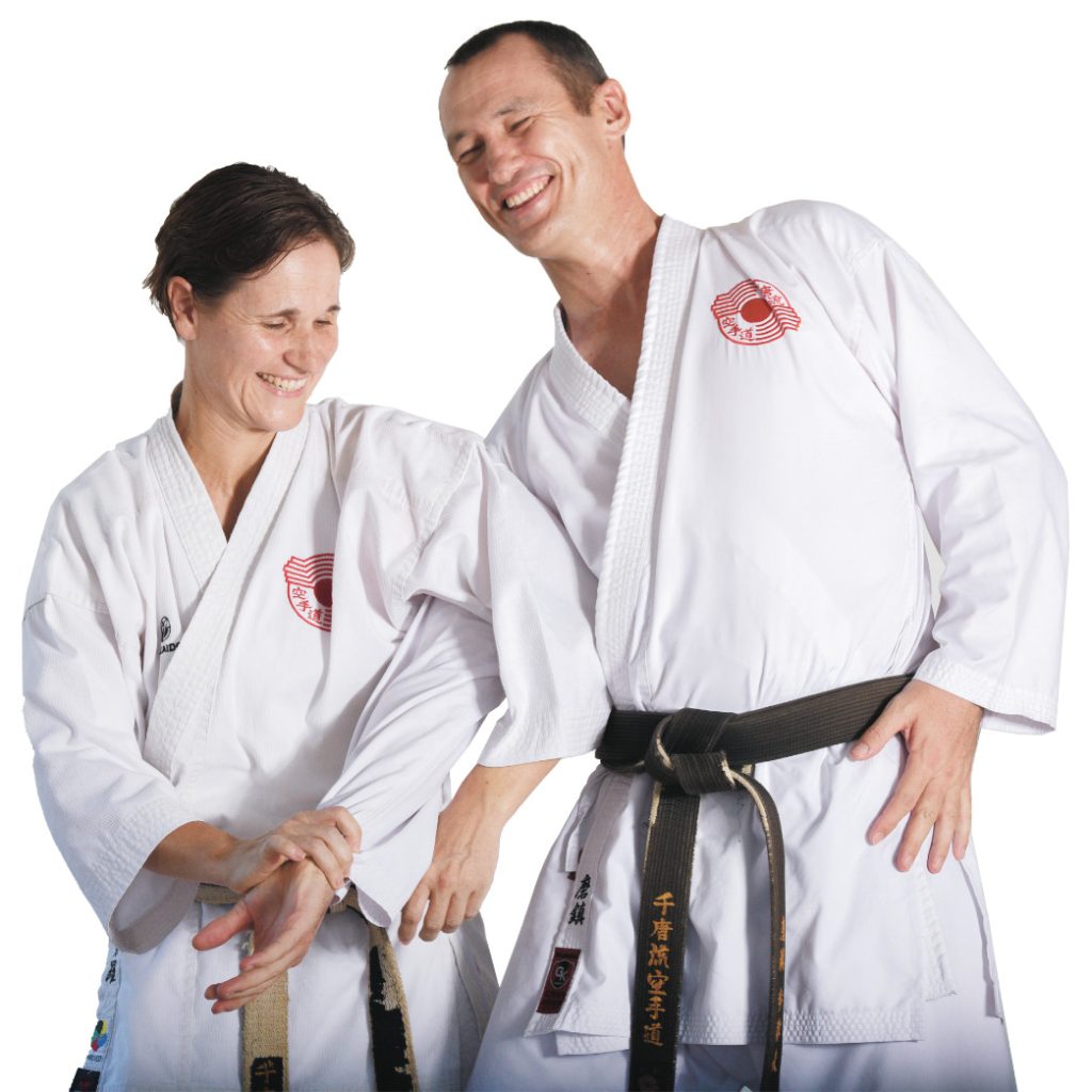 Sensei Martin and Sensei Sandra smiling together in their karate uniforms